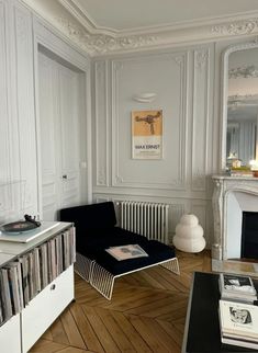 a living room filled with furniture and a fire place next to a wall mounted record player