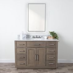 a bathroom vanity with two sinks and a mirror on the wall above it in a white walled room