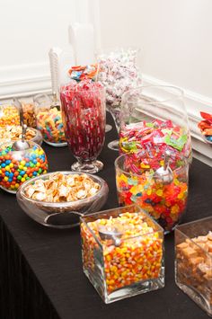 a table topped with lots of different types of candy and candies on top of it