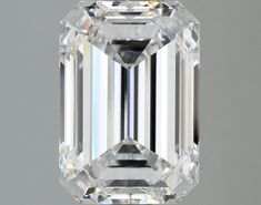 an emerald - cut diamond is displayed on a gray background, with the center stone visible