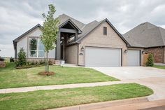 a large house with two garages in the front yard