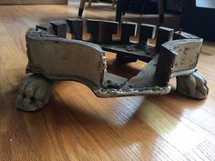 an old cast iron bench sitting on top of a hard wood floor