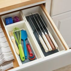 an organized drawer with utensils in it