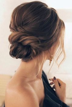 a woman with her hair in a low bun