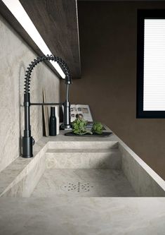 a bathroom sink with a faucet and soap dispenser in it