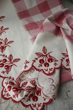 three red and white napkins with cherries on them