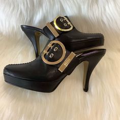 Emilio Pucci Black Leather Slip-On Heeled Clogs In A Size 37 (Us 61/2). They Are Italian Sizing. Semi Pointed-Toe Clogs With Platforms, Tonal Stitching And Buckle Accent At Uppers With The Pucci Logo. These Are Beautiful Shoes And Are In Excellent Preowned Condition, The Only Ware Is On The Soles!!! Size: Eur 37/ Us 61/2 Heel Height: 3.75" Platforms: 0.75" Tapers To 1”. Toe Type: Almond Toe Color: Black Features: Adjustable, Buckle Made In Italy Smooth Leather Clog Style With Open Heel Design Go Designer Open Heel Mules With 4-inch Heel, Elegant Open Toe Clogs With 4-inch Heel, High Heel Clogs With Leather Sole For Work, Luxury Mules With 4-inch Heel And Round Toe, Leather Sole High Heel Clogs For Work, Elegant Clogs With 4-inch Heel And Round Toe, Luxury Leather Clogs With Buckle Closure, Elegant High Heel Clogs With Leather Sole, Chic Leather Clogs For Formal Occasions