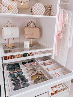 a white closet filled with lots of purses and handbags on top of shelves