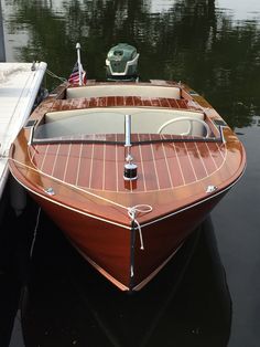 a small wooden boat tied to the dock