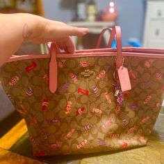 Excellent Condition. No Flaws I Can See. Brown Coach Bag With Candies. Throwing In A Candy Keychain. 17.5in W X 13in H X 6in Depth. Pink Coated Canvas Bag With Removable Pouch, Coach Bags Perfect As Gifts, Coach Bags Perfect For Gifts, Pink Coated Canvas Bag For Everyday Use, Coach Bag For Gift, Everyday Use Pink Coated Canvas Bag, Pink Bag With Detachable Handle In Coated Canvas, Pink Coated Canvas Bag With Detachable Handle, Pink Bags With Detachable Handle In Coated Canvas