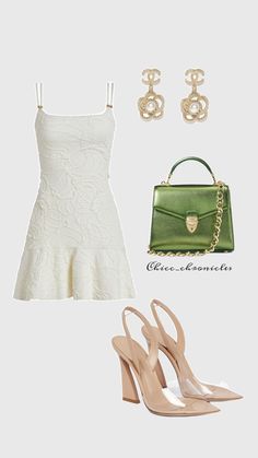 a white dress and green purse next to two pairs of shoes