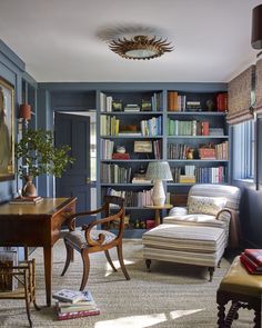 a living room filled with furniture and bookshelves covered in lots of bookcases