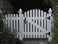 a white picket fence in front of a house