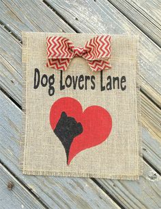 a dog lover's lane sign with a red heart and a bow on it