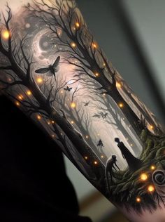 a man's arm with an image of animals in the woods and lights on it