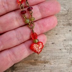 "This fun Boho-inspired necklace brings the warm colors of Autumn to any season. These gorgeous colors should not be limited to just one season a year. For those who look best in Fall and Spring colors, this necklace is for you! The slight differences in the leaf beads make this necklace a naturally unique feel. The larger leaf bead is 10 x 13mm; the smaller beads are 6mm and 3 x 5mm. All items in this series are shown in antique brass but can be made in gunmetal or silver. This necklace is 16 - Handmade Red Nature-inspired Necklace, Red Bohemian Necklace With Lobster Clasp, Bohemian Red Necklace With Lobster Clasp, Czech Glass Dangle Necklaces As Gift, Red Bohemian Nickel-free Necklace, Bohemian Red Nickel-free Necklace, Bohemian Czech Glass Necklaces For Gifts, Bohemian Czech Glass Necklace For Gift, Bohemian Czech Glass Necklace As Gift