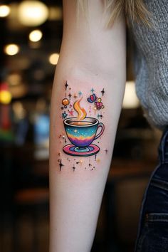 a woman's arm with a cup of coffee and stars tattoo on the left forearm