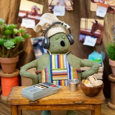 a stuffed animal with headphones on sitting at a table