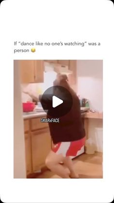 the woman is dancing in the kitchen with her feet up on the counter and wearing red shorts