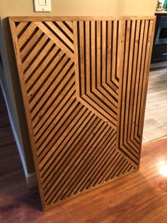 a large wooden cabinet sitting on top of a hard wood floor next to a wall