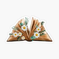 an open book with daisies and leaves on it sticker is sitting on a white surface