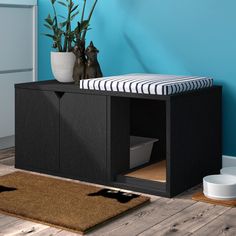 a dog bed in the corner of a room with blue walls and wood flooring