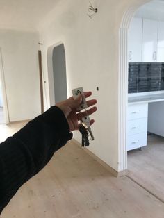 a person is holding keys in their house