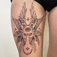 a woman's thigh with an owl and moon tattoo design on her lower leg