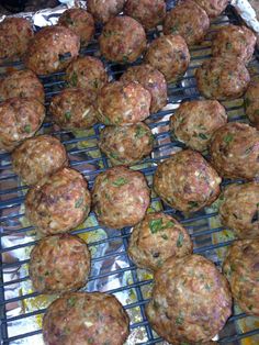 some meatballs sitting on top of a grill