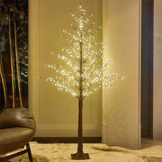 a lighted tree in the corner of a room