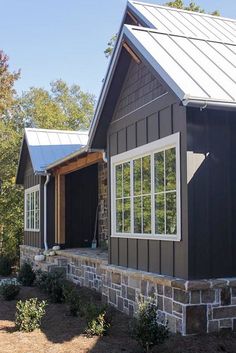 a black house with white trim and windows