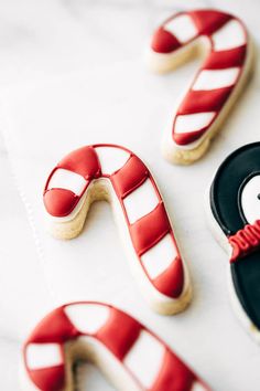 decorated cookies and candy canes on a table