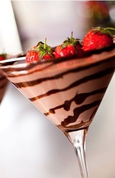 two glasses filled with chocolate and strawberries