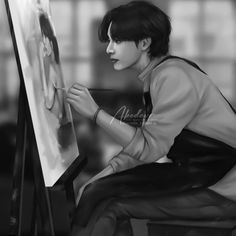 a black and white photo of a person sitting in front of an easel painting