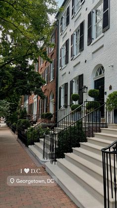 the stairs lead up to an apartment building with black iron railings on each side