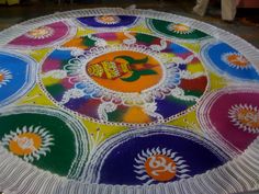 a colorfully painted table with an omelette on it's surface and people walking around