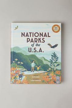 national parks of the u s a book on a gray surface with an eagle flying over it