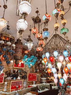 many colorful lights hanging from the ceiling in a store