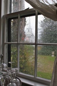 an open window with rain coming in from the outside