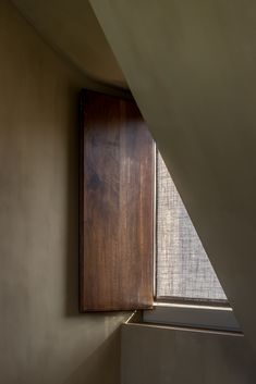 the corner of a room with a wooden window