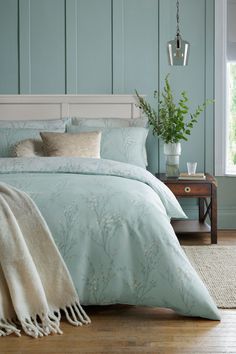 a bed in a bedroom with blue walls