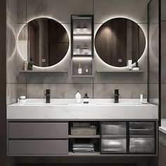 a bathroom with two sinks and three mirrors