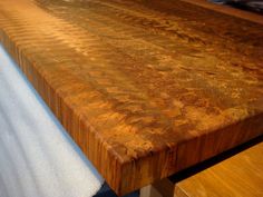 a close up of a wooden table with benches in front of it on a carpeted floor