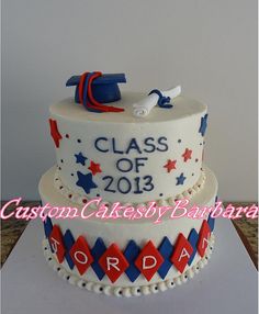 a three tiered graduation cake decorated with red, white and blue icing for class of 2013