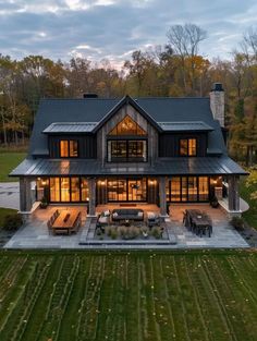 an aerial view of a large house in the middle of a grassy area with trees and grass