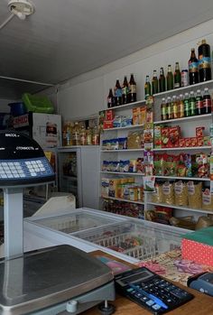 a store filled with lots of food and condiments next to a cash register