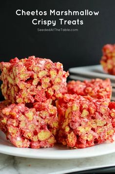 some red and yellow treats on a white plate with the words cheetos marshmallow crispy treats