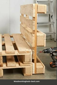 a bench made out of wooden pallets with a drill and screwdriver next to it