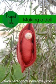 an ornament hanging from a tree in the shape of a red birdhouse