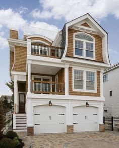 a two story house with three car garages